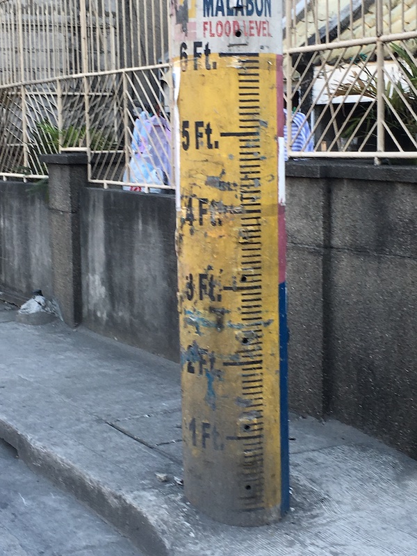Cement pole painted with flood measurement markers