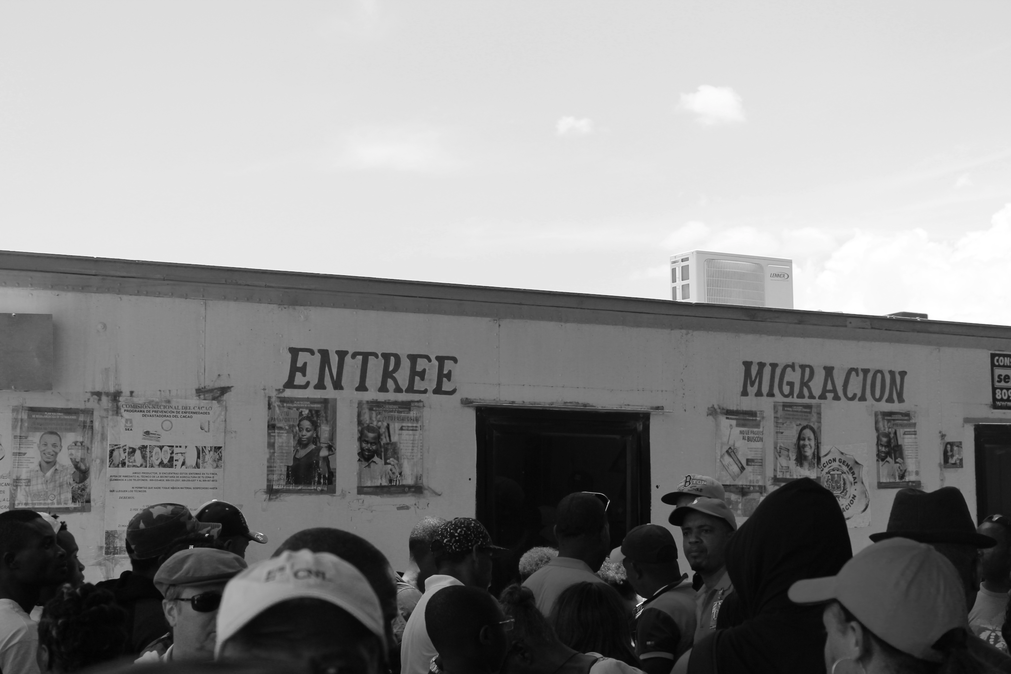 Tourists and Haitian migrants waiting in line at the migration processing center to enter the Dominican Republic.