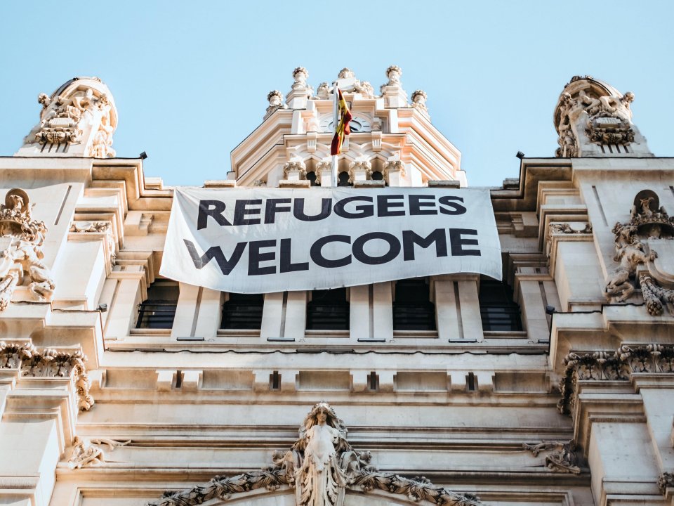 Refugees Welcome banner on building in Madrid, Spain