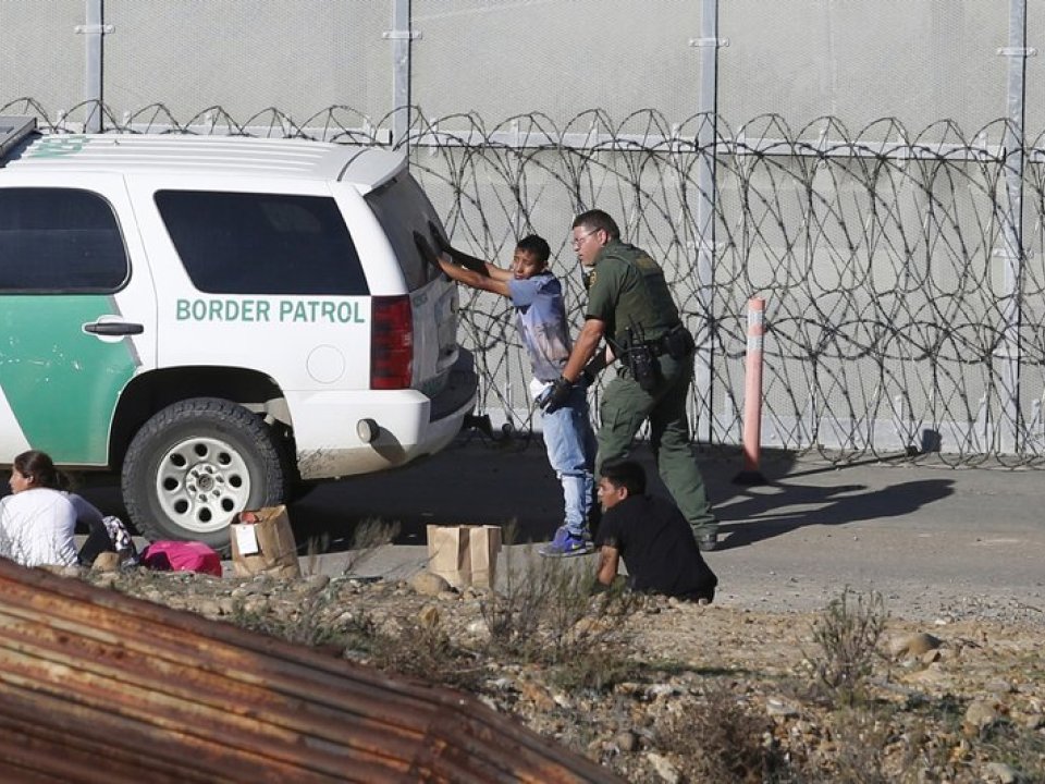 Man being detained by border patrol 