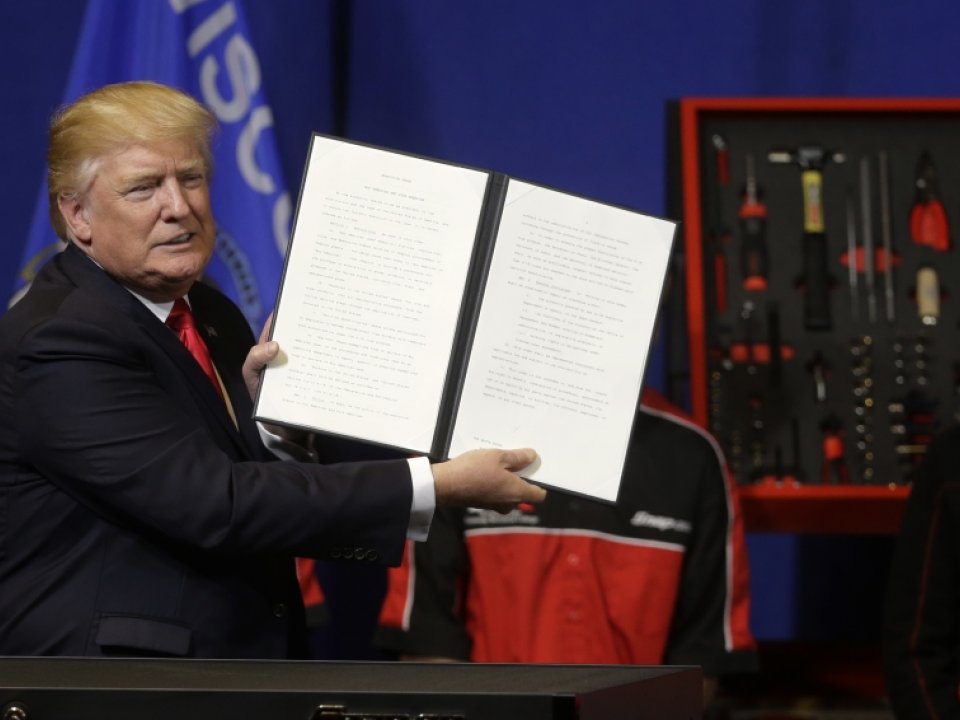 President Donald Trump holding up bill