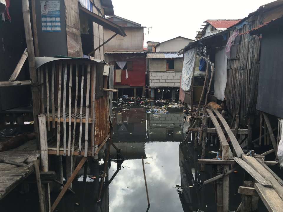 Homes sit on stilts above flood waters in the Philippines