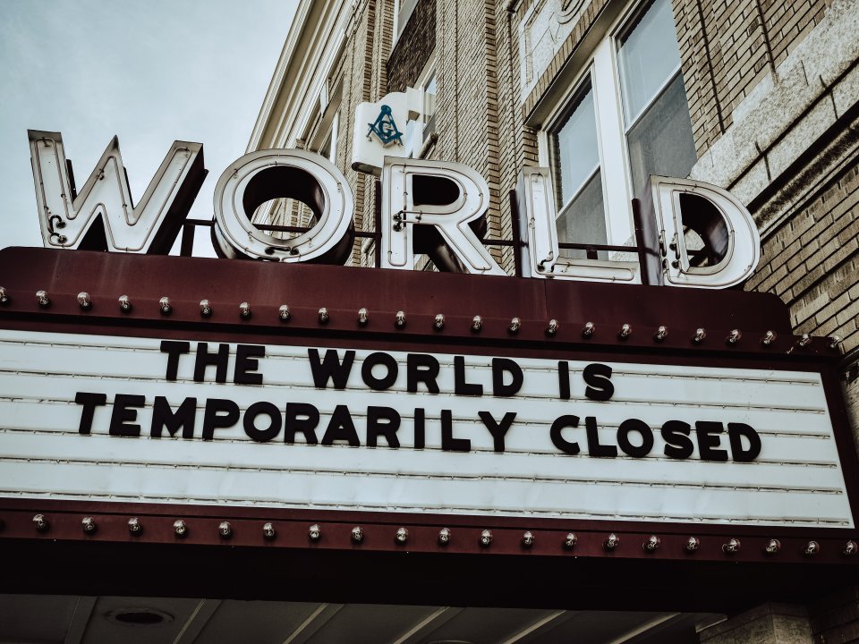 Theater sign that says, "The World Is Temporarily Closed"