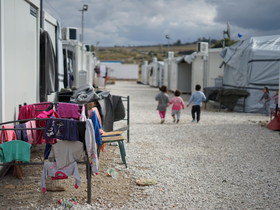 Children walking between shelters in Syrian refugee camp