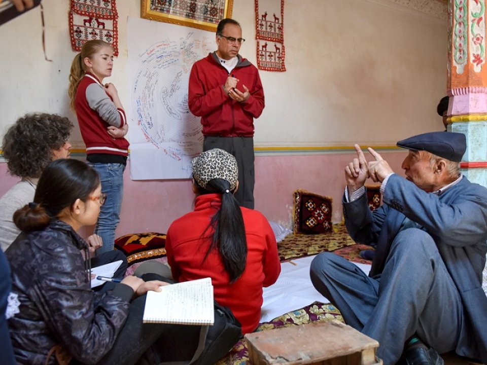 Professor Karim-Aly Kassam meets, standing at center, talks with herders and farmers in Post Doct Village in Xinjiang, China.