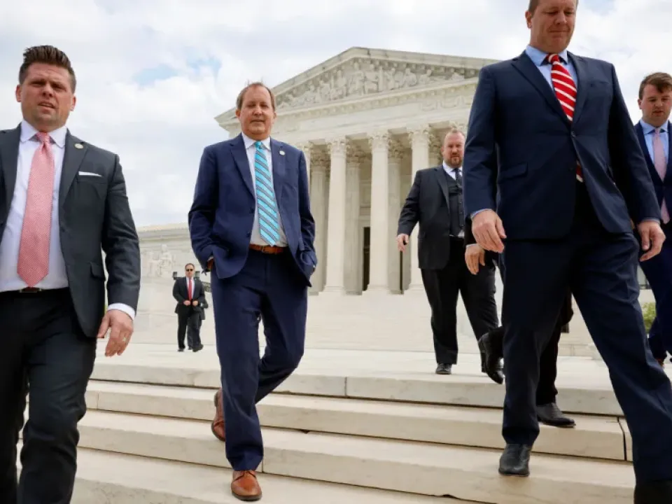 Texas Attorney General Ken Paxton (C), Texas Solicitor General Judd E. Stone and Missouri Attorney General Eric Schmitt walk out of the U.S. Supreme Court after arguments in their case about Title 42 on April 26 in Washington, DC.