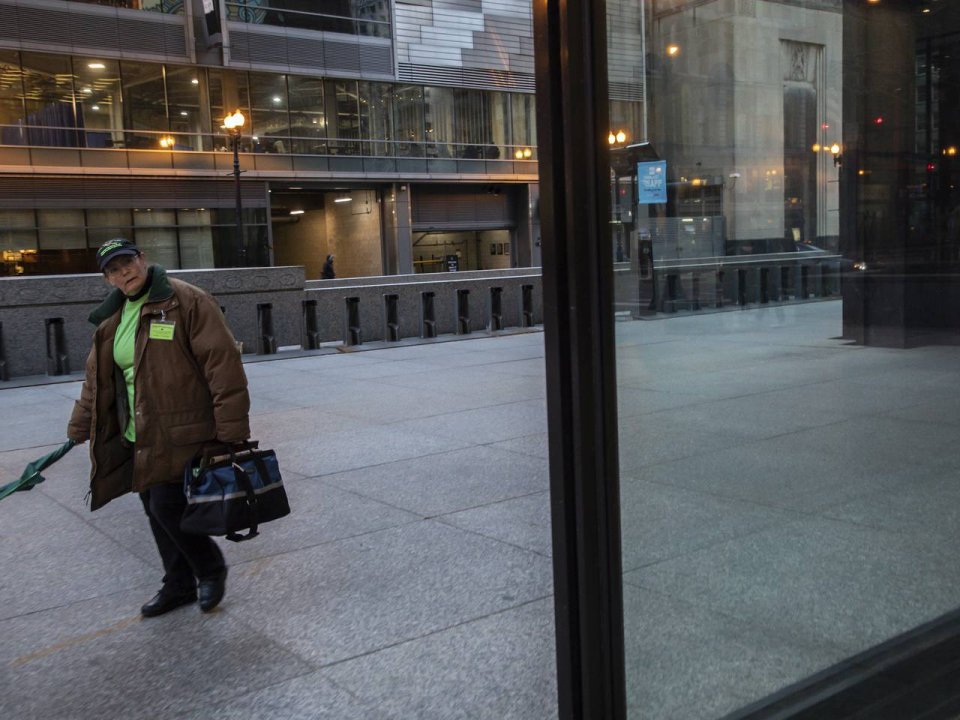 Annette Prince, director of the Chicago Bird Collision Monitors, a group of volunteers, searches for birds on the sidewalks early in the morning at Daley Plaza in Chicago on April 2, 2019