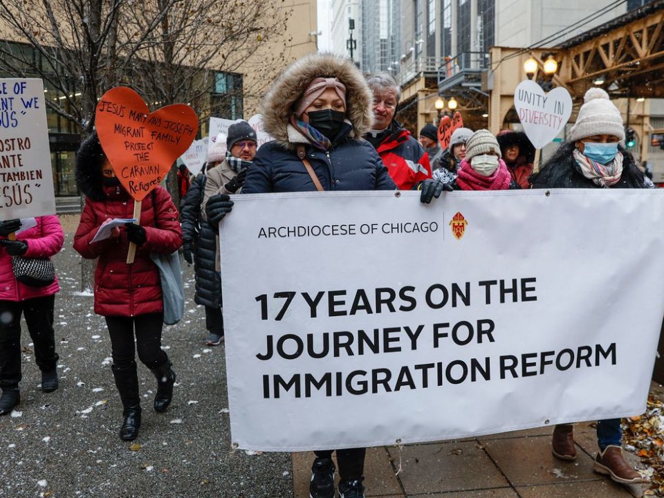 People hold signs and march outside a U.S. Citizenship and Immigration Services facility in Chicago on Dec. 16 during the “17th Annual Posada for Immigration Reform.” Posadas are a celebration of the Christmas story, including Mary and Joseph’s search for shelter before Christ’s birth.