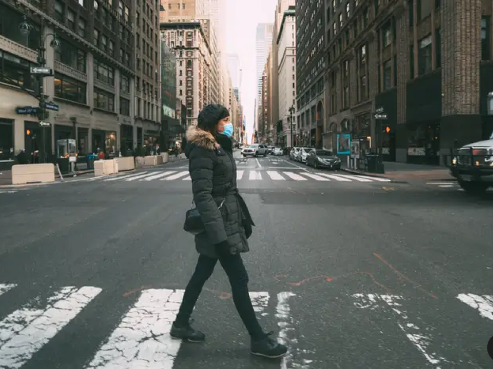 Woman crossing city street