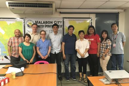 Lindy Williams stands with city officials in Malabon, Philippines