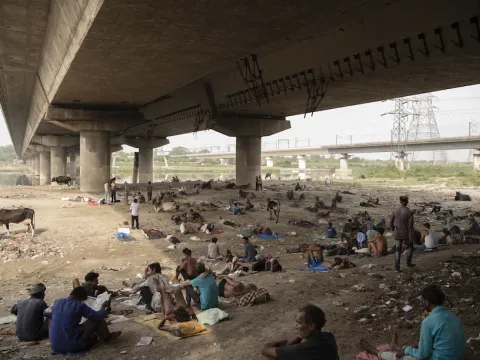People rest under a bridge in New Delhi on May 29 as the northern region of India experienced the warmest weather in 122 years