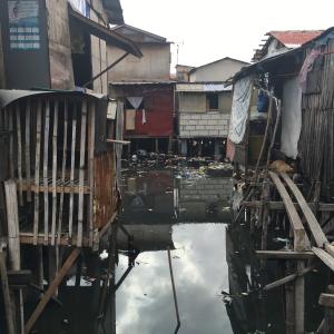 Homes sit on stilts above flood waters in the Philippines